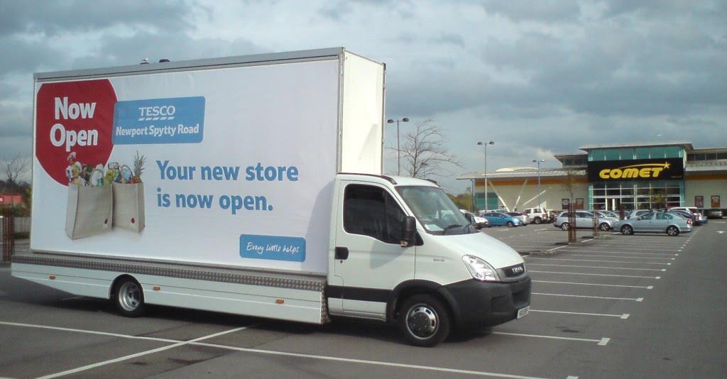 Poster advertising van displaying printed campaign artwork